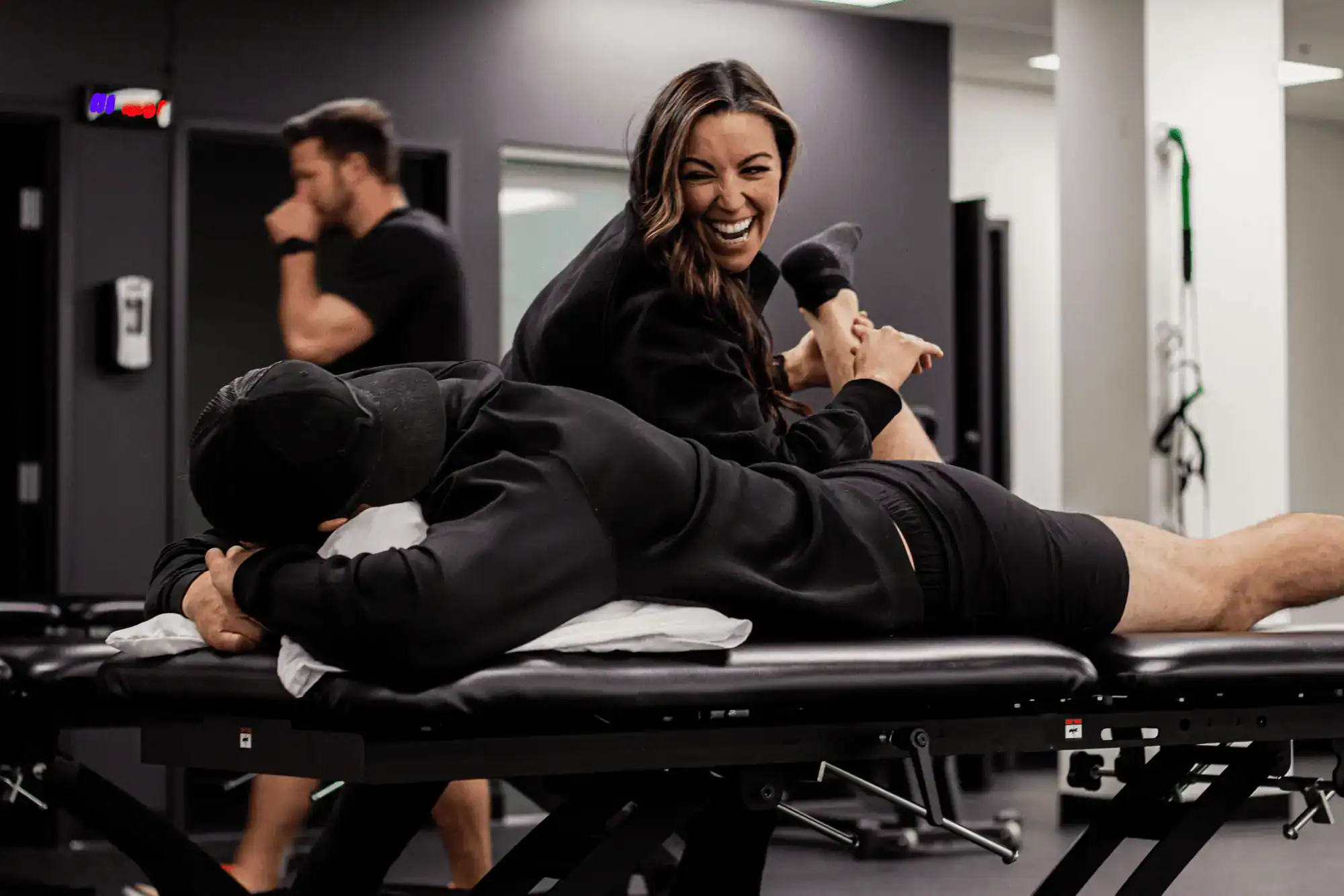 Clinician assisting patient during rehabilitation treatment session
