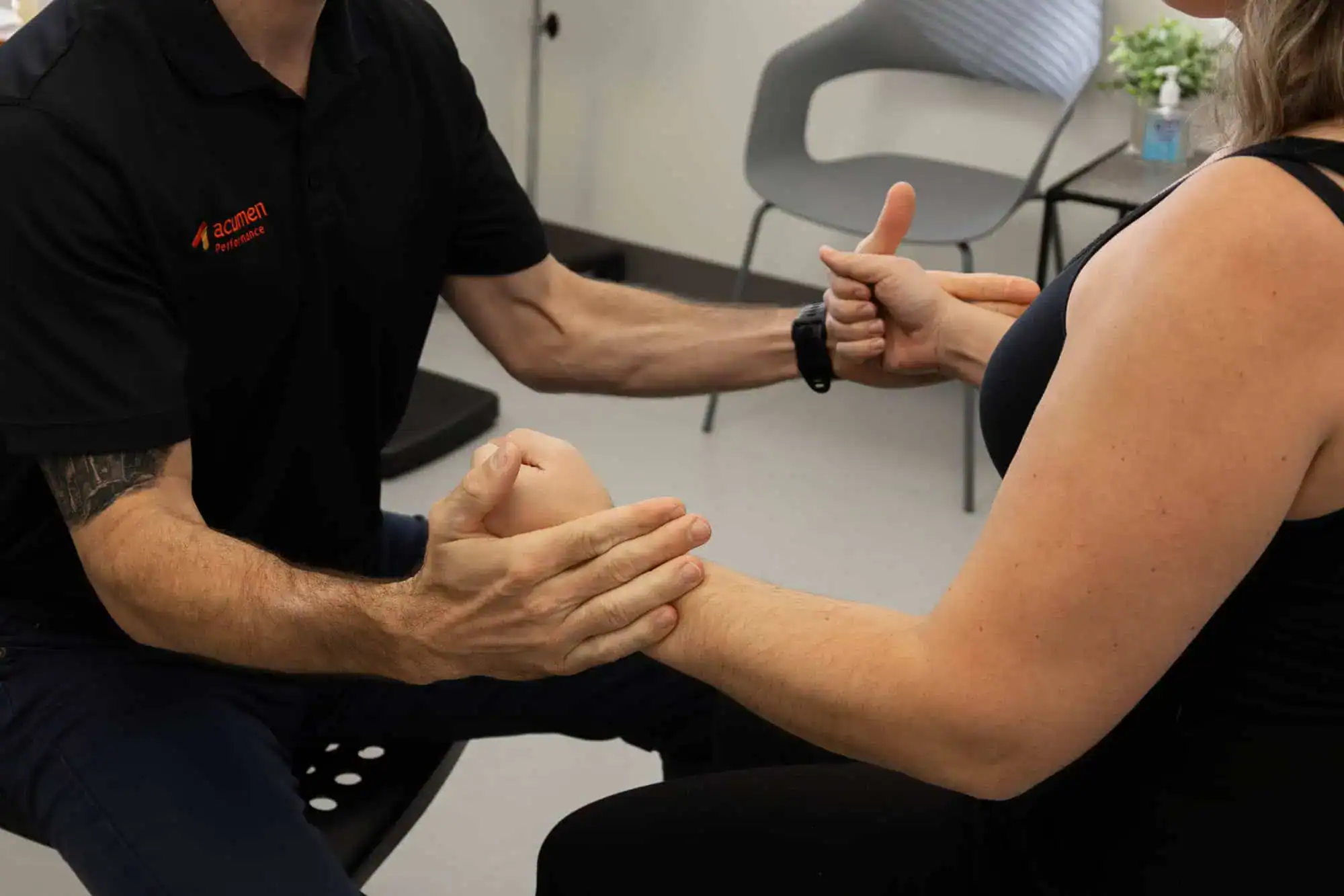 Clinician assessing patient’s arm during private surgery consultation