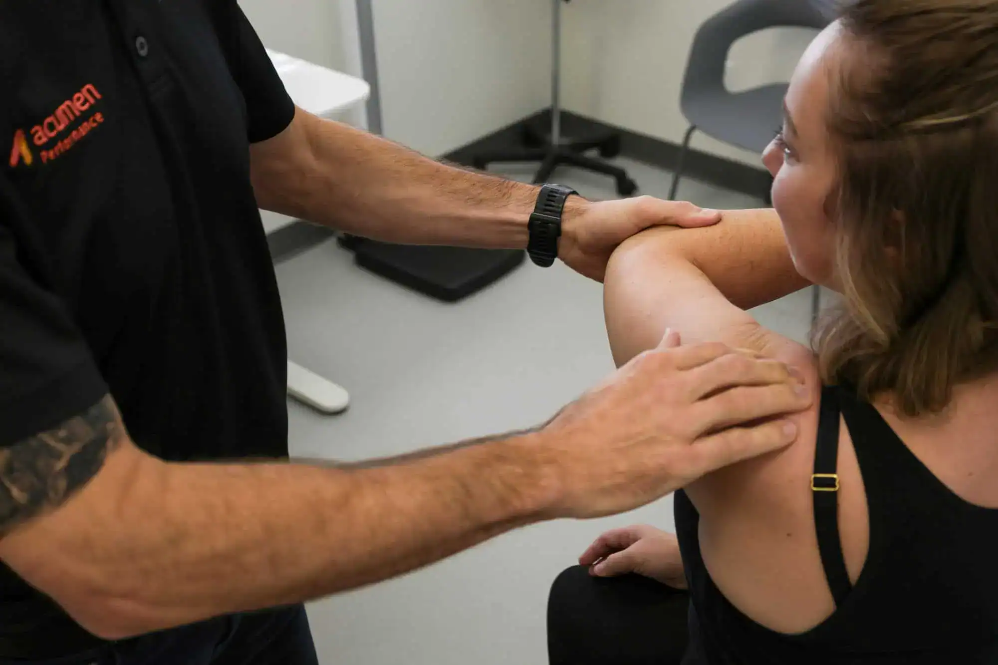 Clinician examining patient’s shoulder for surgical care