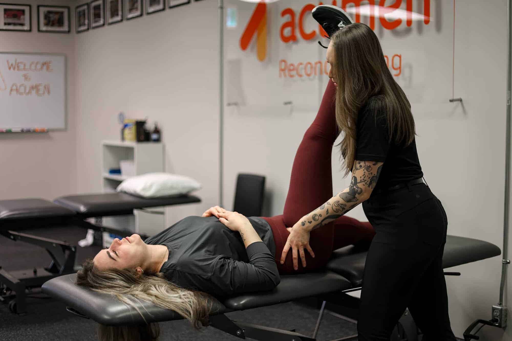 Clinician assisting patient during hip examination